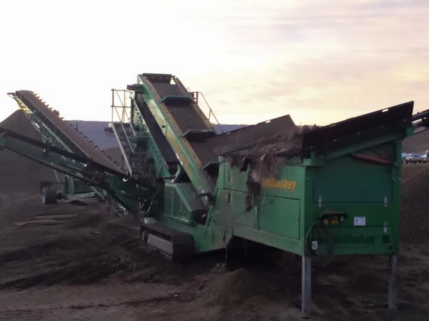 Portable screening and crushing plant working a gravel stockpile